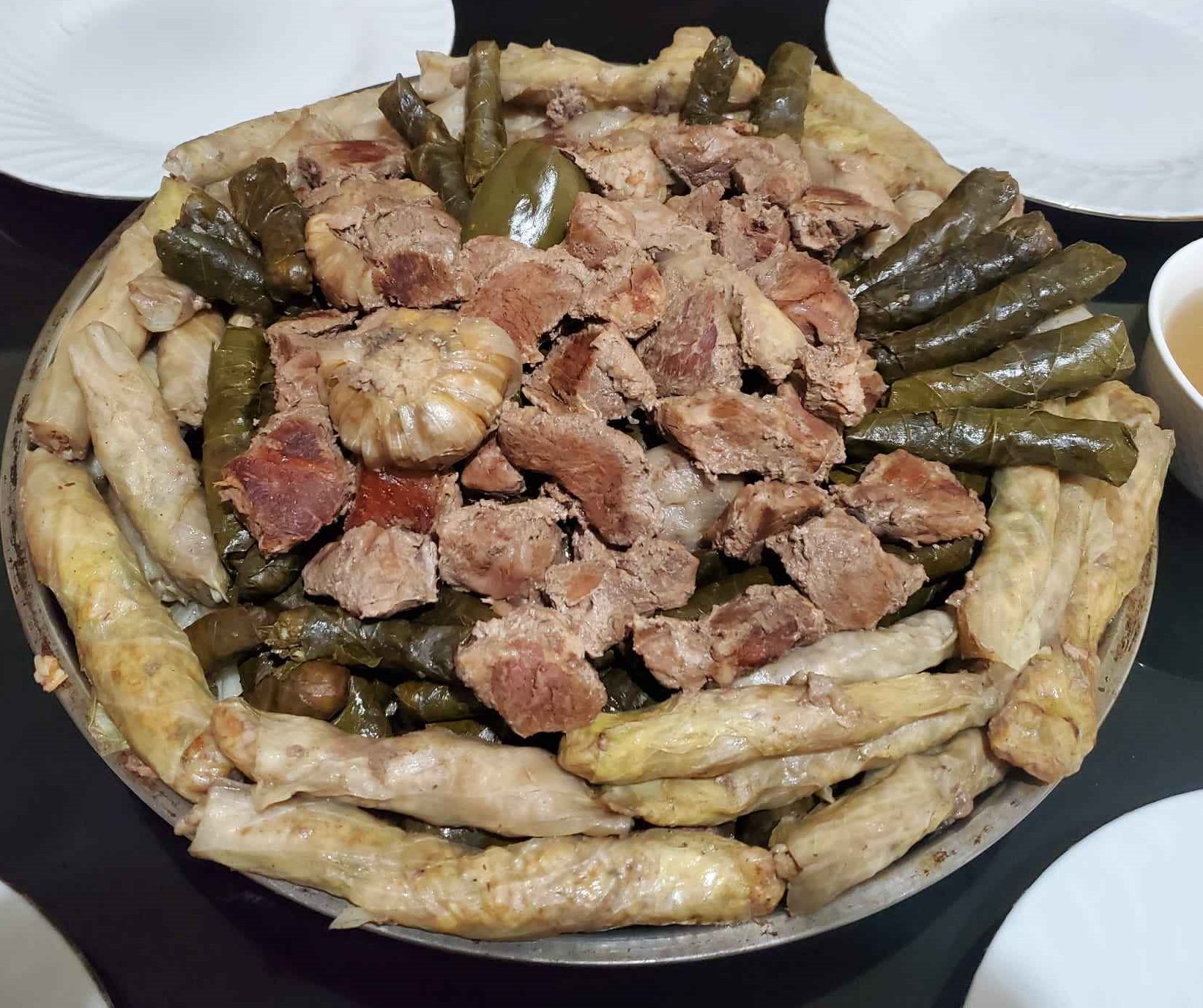 A plate of Yaprak Dolma stuffed vine leaves arranged neatly on a dish.